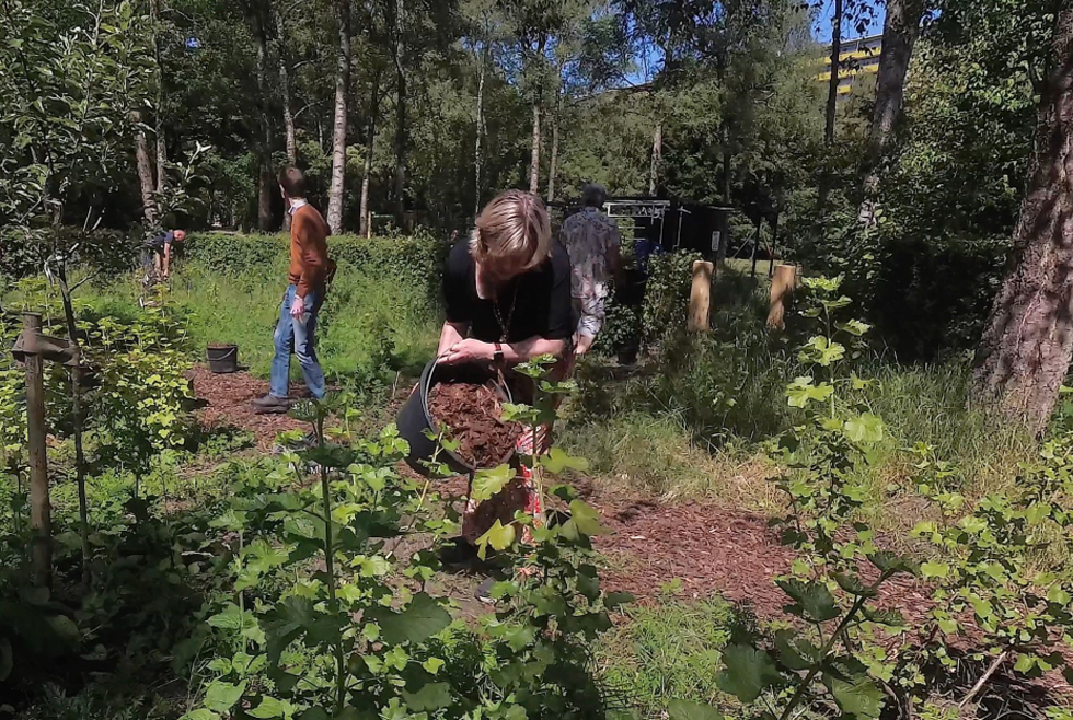 Foto van wethouder Laura Hoogstraten die tijdens de opening aan het werk is in de Voedselbosrand